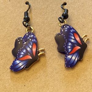 Cute purple and pink butterfly earrings with black wires and random gift bag.